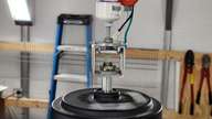 A 2-inch piece of scrap unistrut forms the transition from hanger to fan motor.