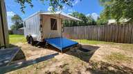 I've been using that tarp for shade for literally decades. Now it keeps the proud tradition going in style. In actual use, the deck is level, not slanted.