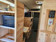 The Pantry. It can hold 4 of these crates, which is quite a bit of storage. The wood finish is actually a waste-use. Those 1/4 x 1-1/2 strips were left over from ripping 2 x 4's to make the 1-1/2 x 1-1/2 framing boards. Turns out they make great wall material.