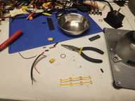 I could just buy a light, but why would I do that when I'm pretty sure I have everything I need around here to make one.  A stainless steel cat dish will make a great reflector, and some self-stick LED strip fits the bill.