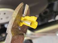One pair of pliers to hold it, and flush-cutters to strip the plastic.