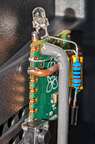 Here's a nice clear view of the IR emitter.  One leg soldered to GND, the other to the resistor. It may look like it's touching the PCB, but it's not.